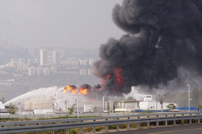 A blaze can be seen after fire erupted in a fuel tank at Oil Refineries Ltd in the Israeli northern city of Haifa December 25, 2016. REUTERS/Jinipix ISRAEL OUT. NO COMMERCIAL OR EDITORIAL SALES IN ISRAEL. - RTX2WERE